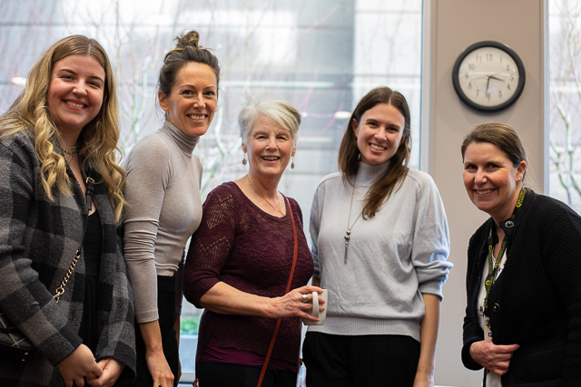 Five OAGBC staff smiling at the camera during an office event