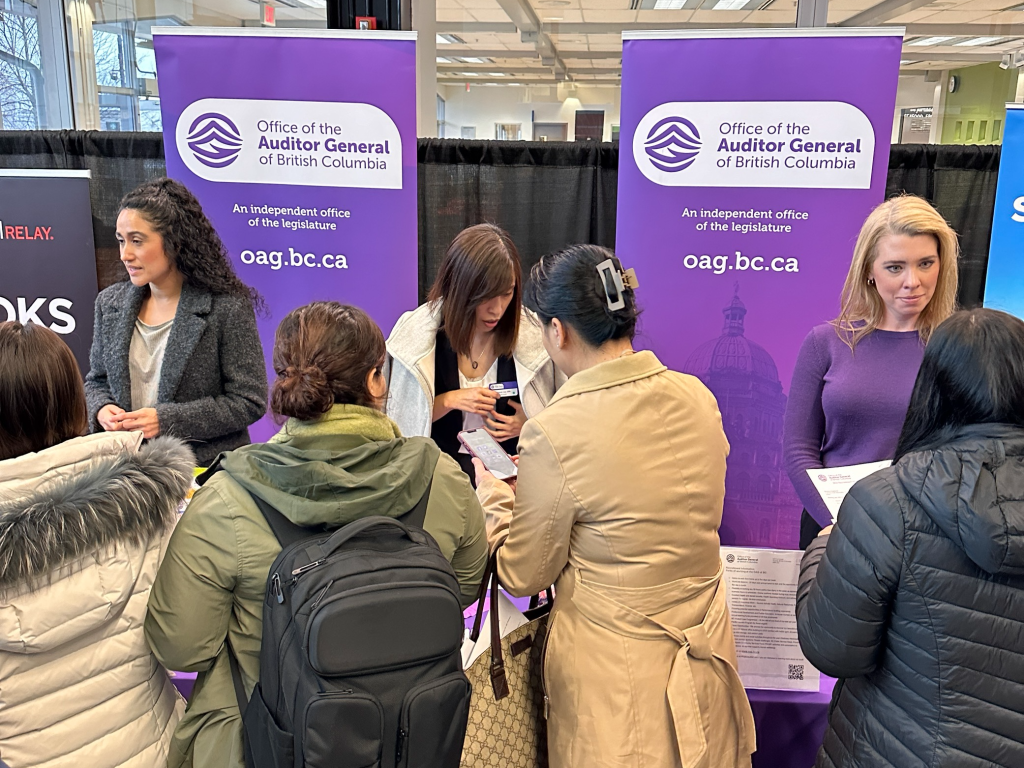 people crowded around OAGBC HR display during a recruitment fair at BCIT