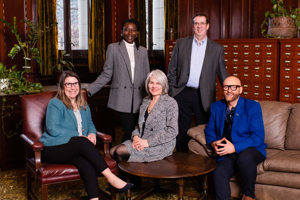 Diverse group of OAG executive posing in the B.C. legislature's library reading room.