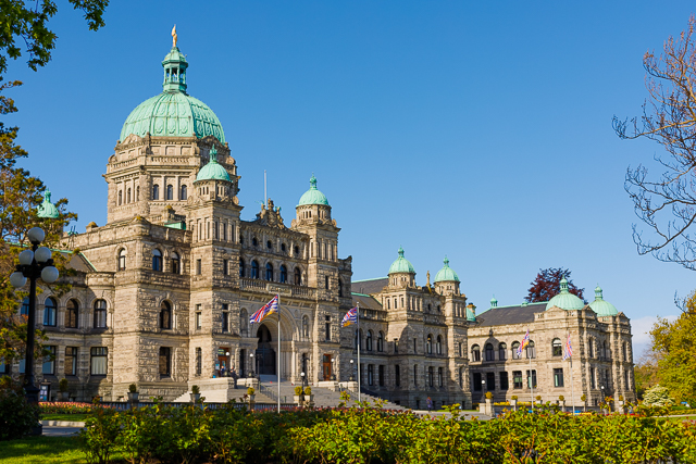 The B.C. Parliament Buildings with morning sun and blue sky