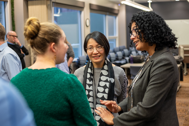 Staff converse at an office event