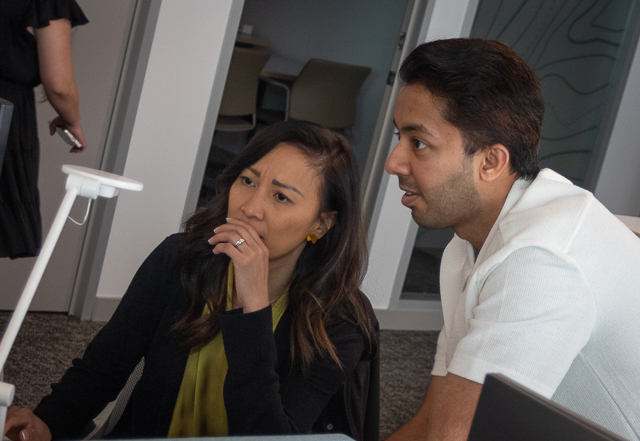 Two auditors discussing spreadsheet on computer