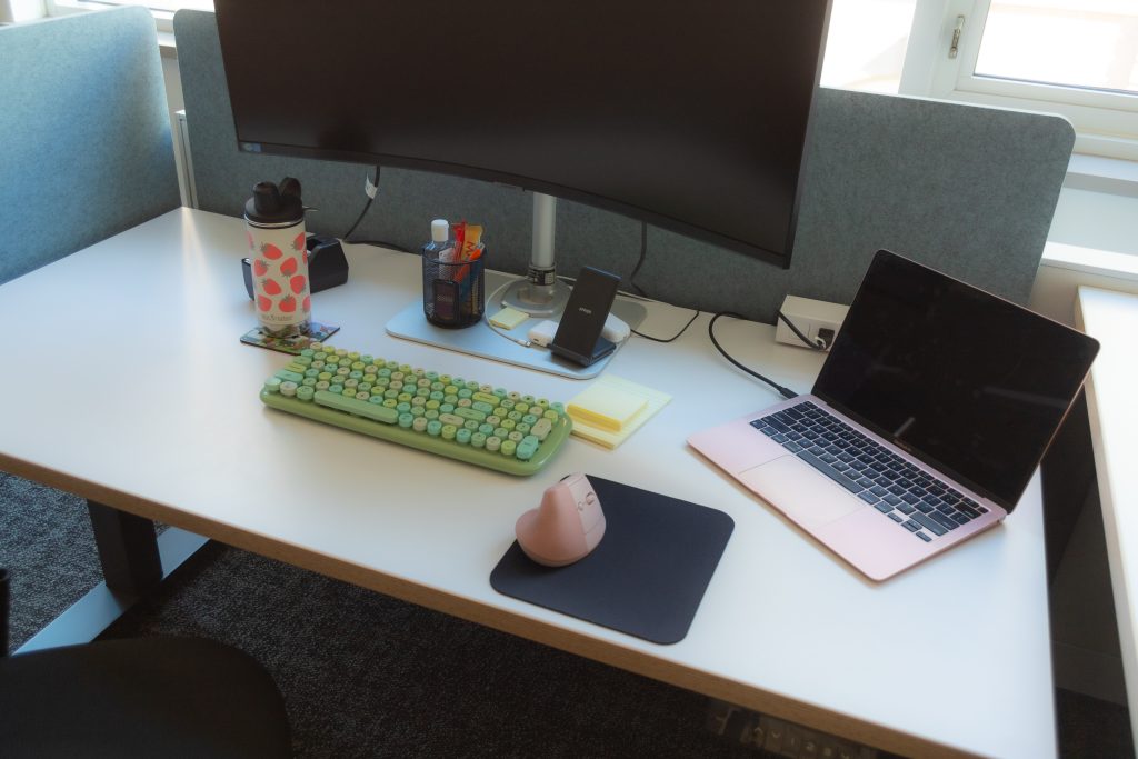 Height-adjustable desk with ergonomic computer keyboard and mouse.